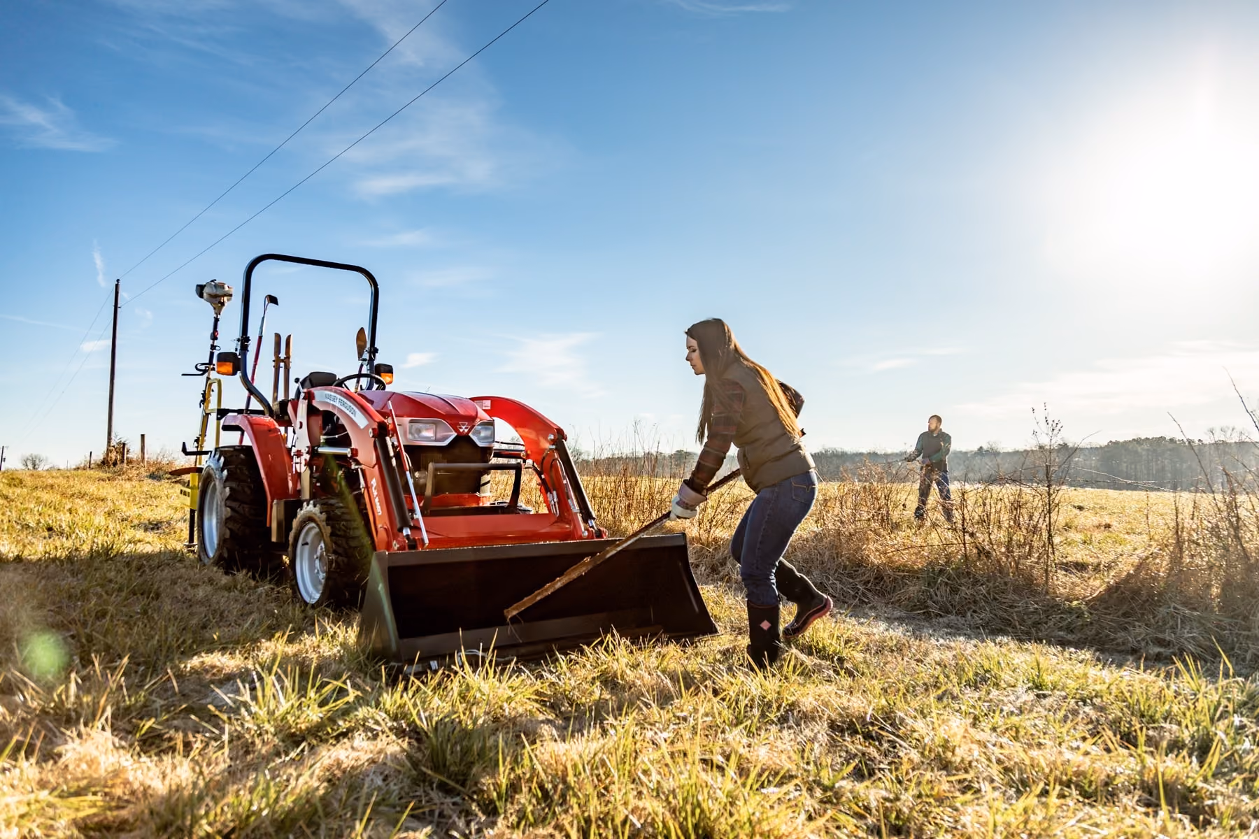 Massey Ferguson compact tractor with a loader in a field