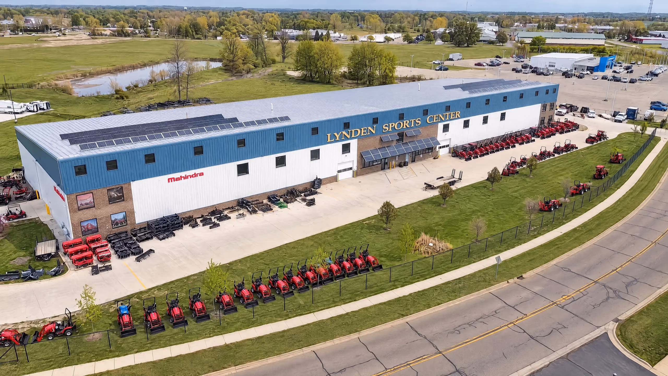 Aerial view of the dealership lot with tractors lined up